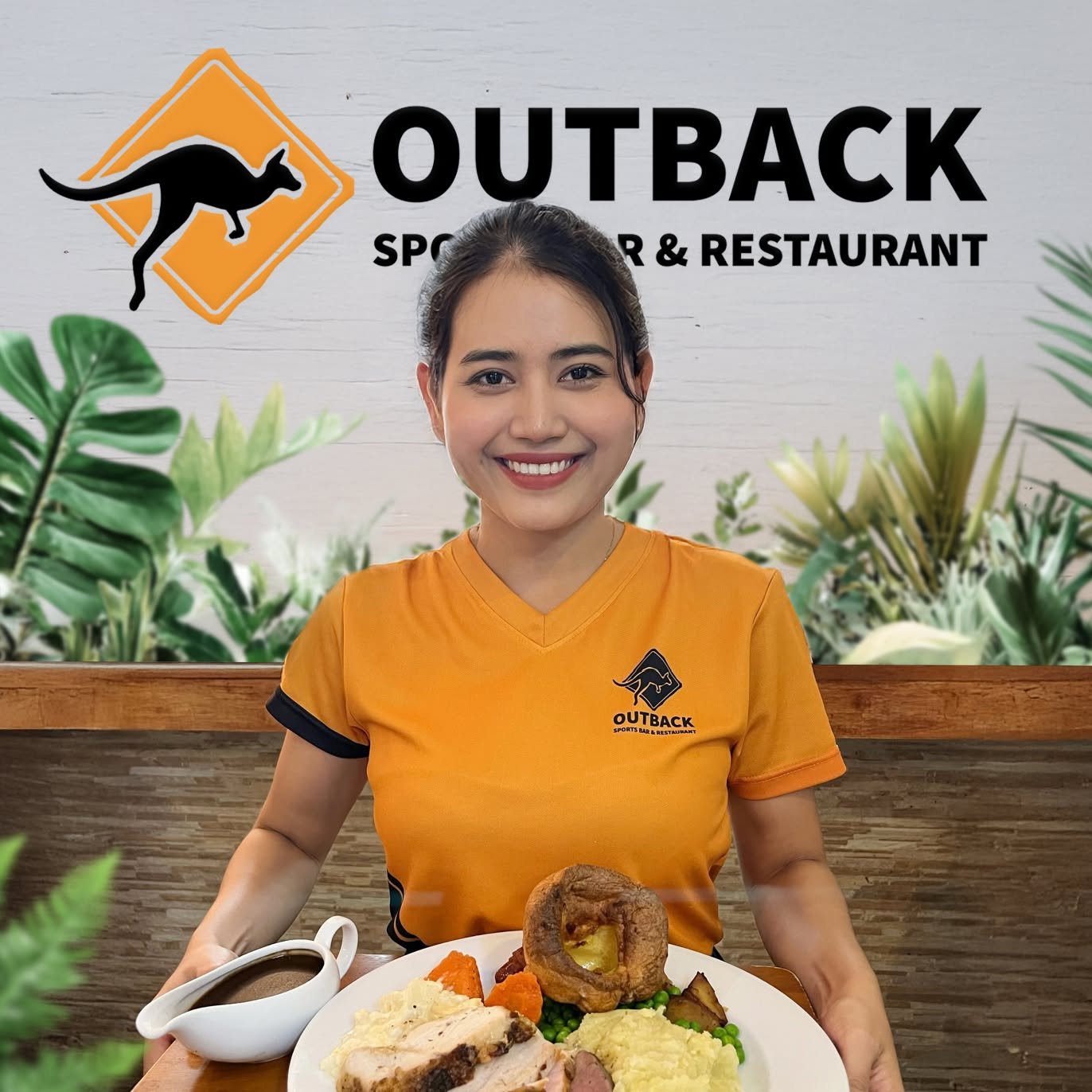 Outback server bringing a Sunday roast